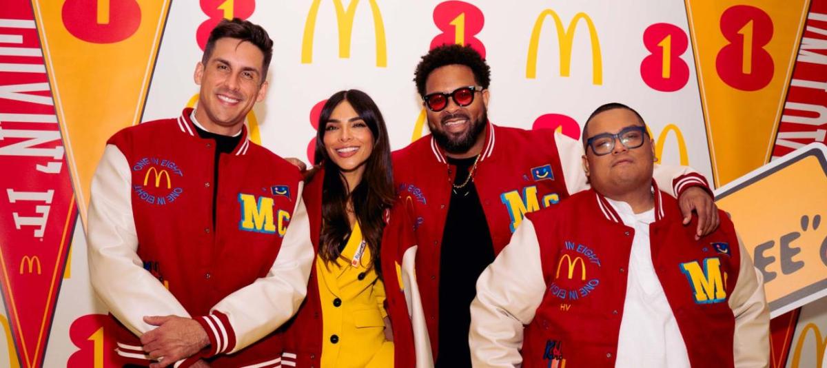 Four people standing together in McDonald's letter jackets