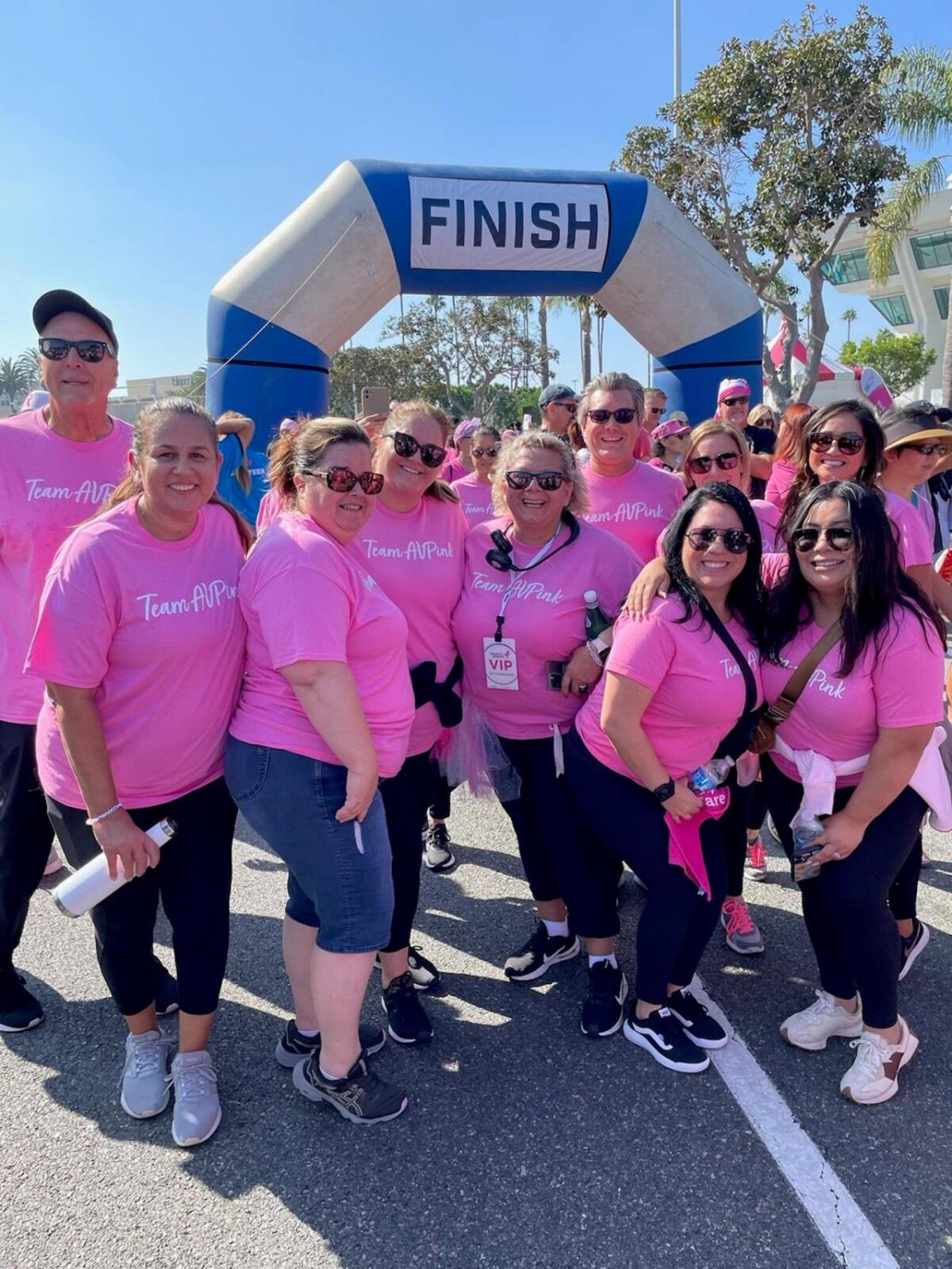 People pose at the finish line of the Orange County, CA Susan G. Komen More than Pink Walk.