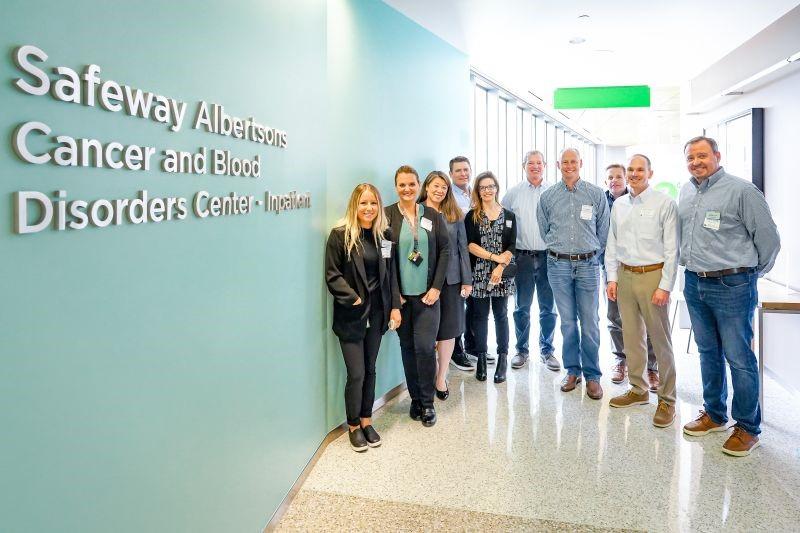 Group of people next to the new Safeway Albertsons Cancer and Blood Disorders Center sign