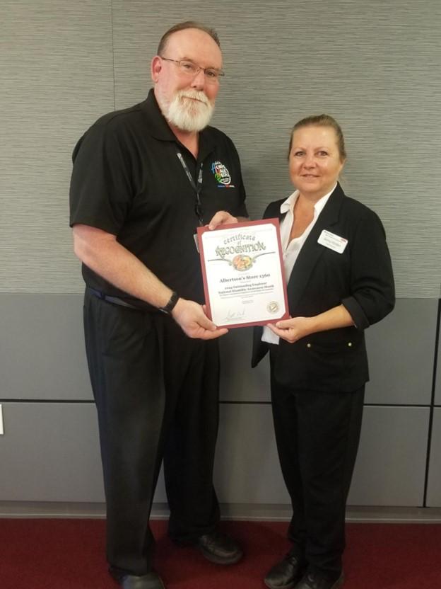 Two people holding a plaque