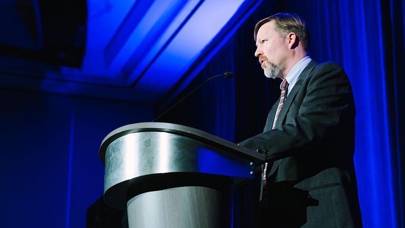 Mark Dresser standing at a podium