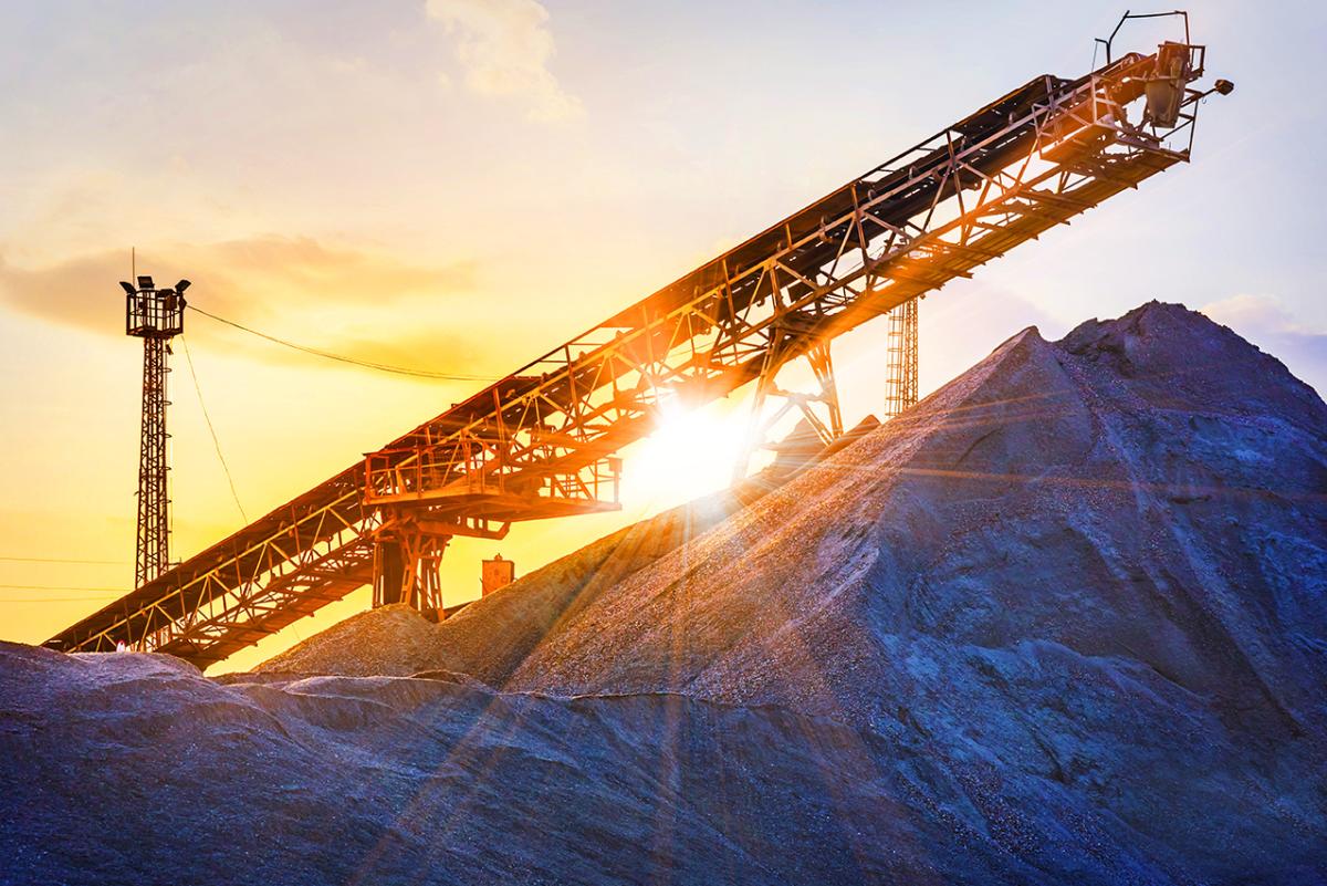 Mining equipment with a sunrise behind it