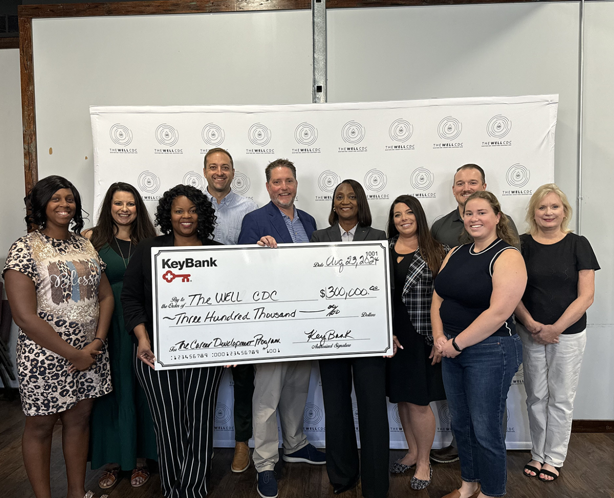 A group of people posing with an oversized check