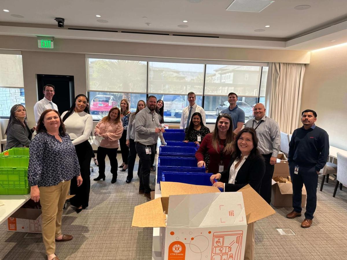 A group of people packing hygiene kits