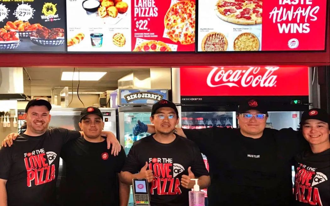 Employees standing together inside a restaurant