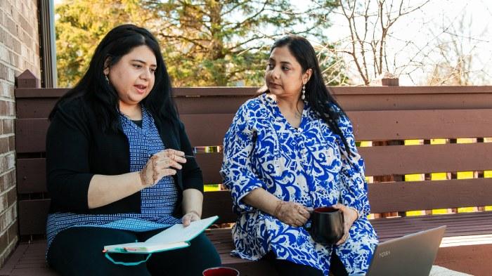 Syeda and her sister Darakhshan sat on a bench