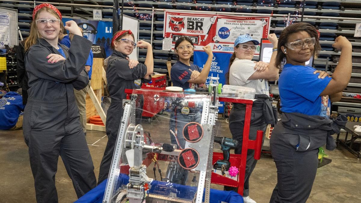 People making fists next to robotics