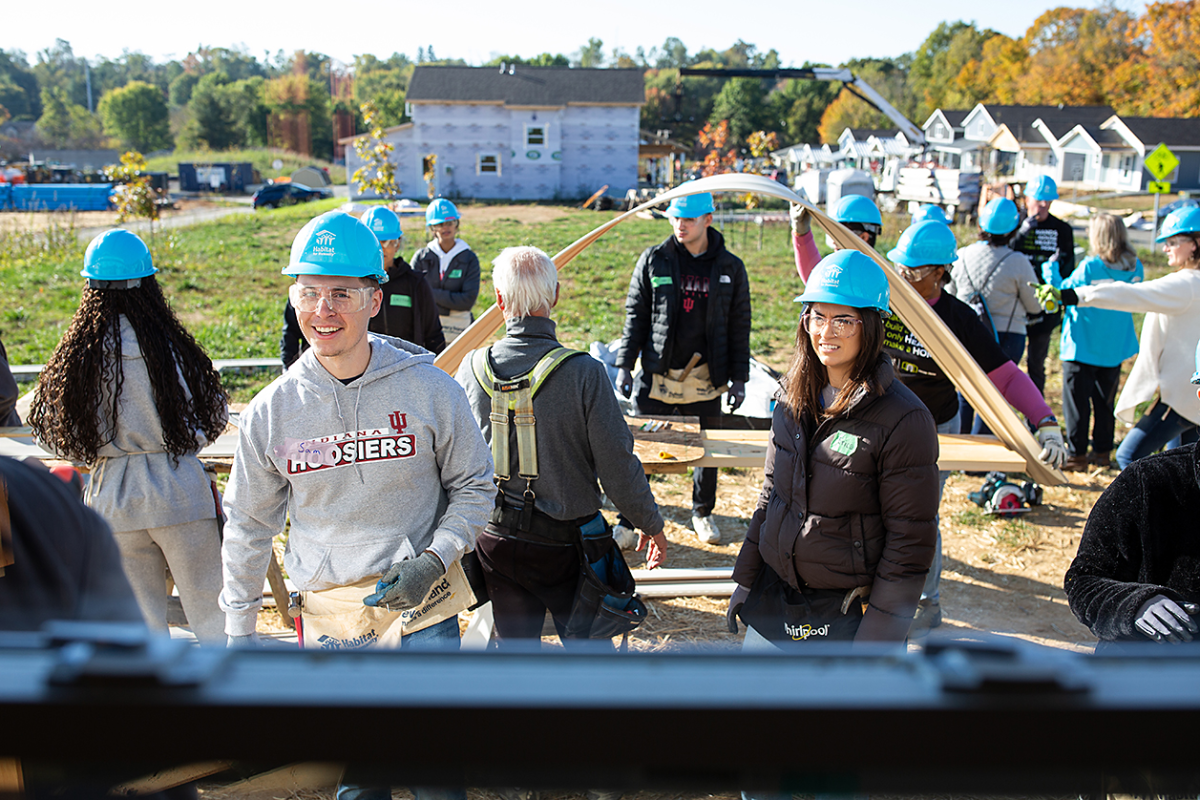 A group of people in blue hard hats working outside