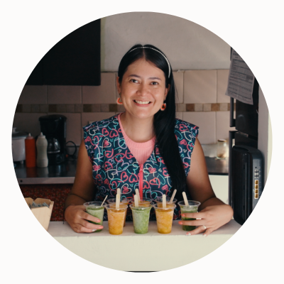 a person sitting at a table in a kitchen