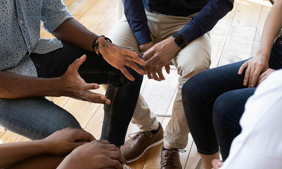 hands, arms and legs of patients sitting in a close circle