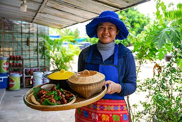 Woman holding tray of food 