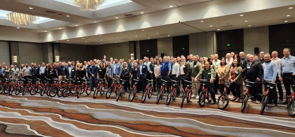 Arrow electronics employees pose with newly built bikes.