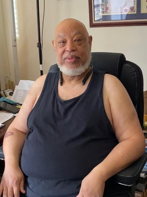 Ronald seated in his home.
