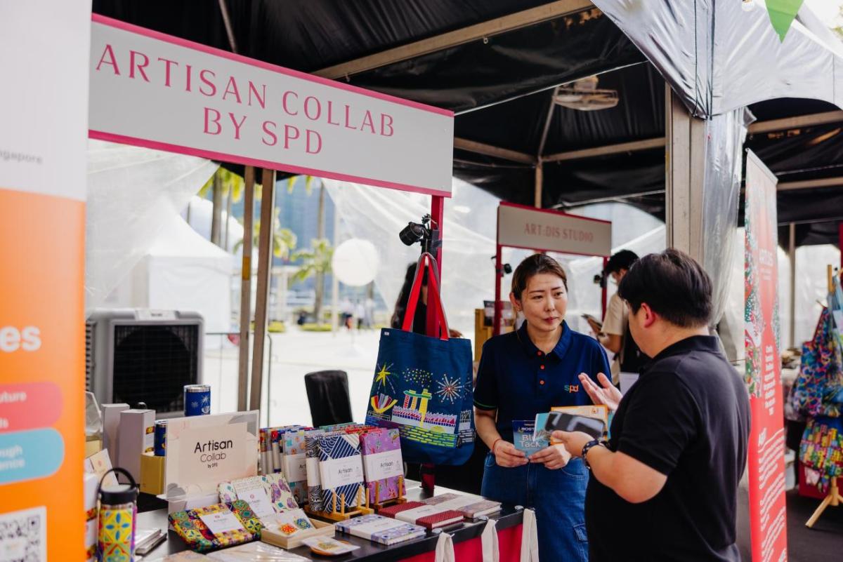 Two people talking at a booth
