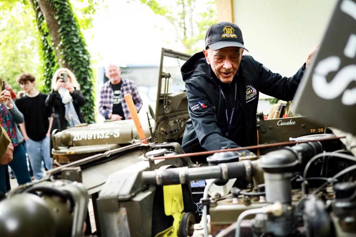 Someone looking at a vehicle engine 