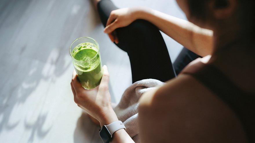 Person holding a green drink