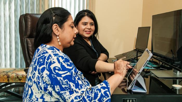 Syeda and her sister Darakhshan using a tablet PC