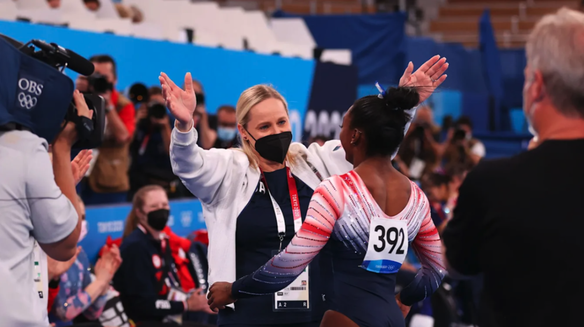 Someone about to hug a gymnast