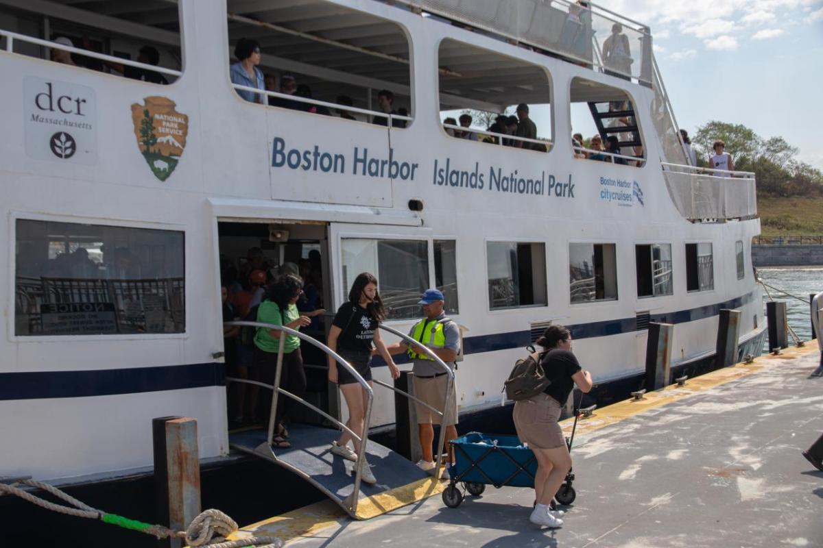 People stepping off of a ferry boat