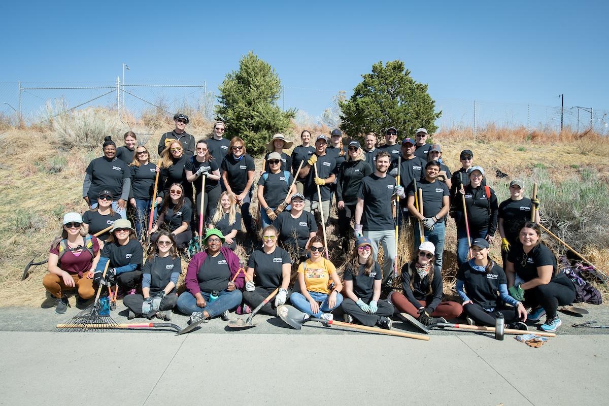 Arrow employees pose for a group photo while planting trees on Earth Day 