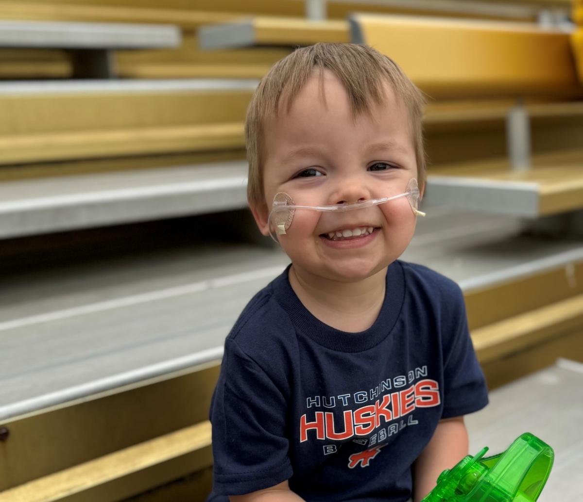 Toddler Cameron Olson shown with breathing apparatus.