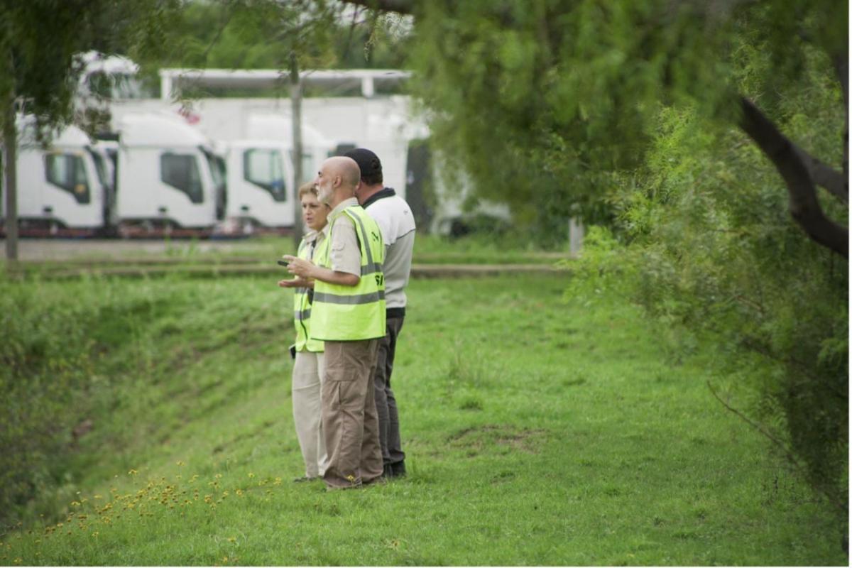 3 people meet out in the field