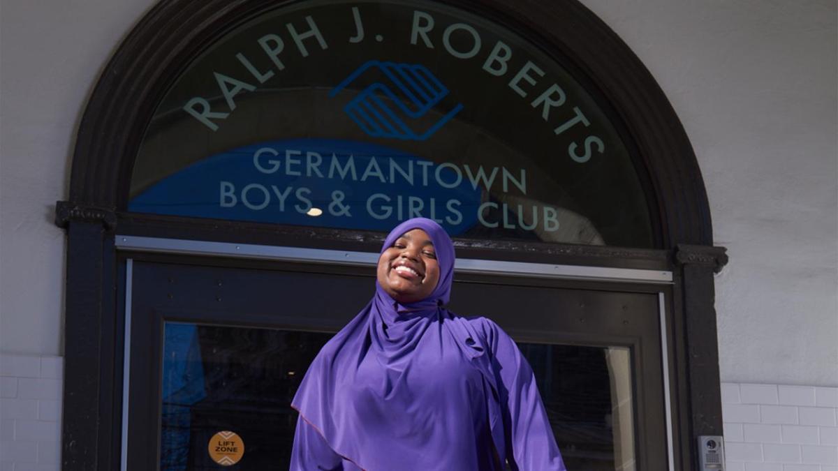 person smiling in font of the Boys and Girls Club