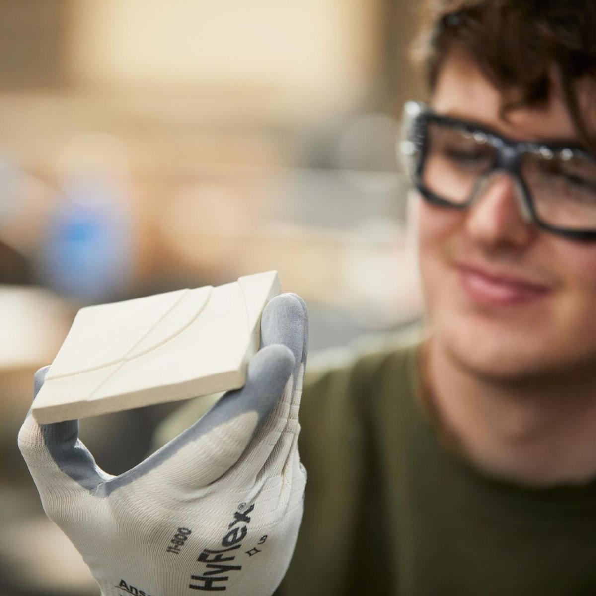 A person holding a tile