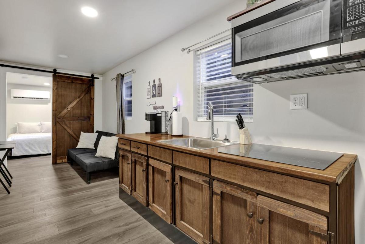 View of kitchen with bedroom visible behind it