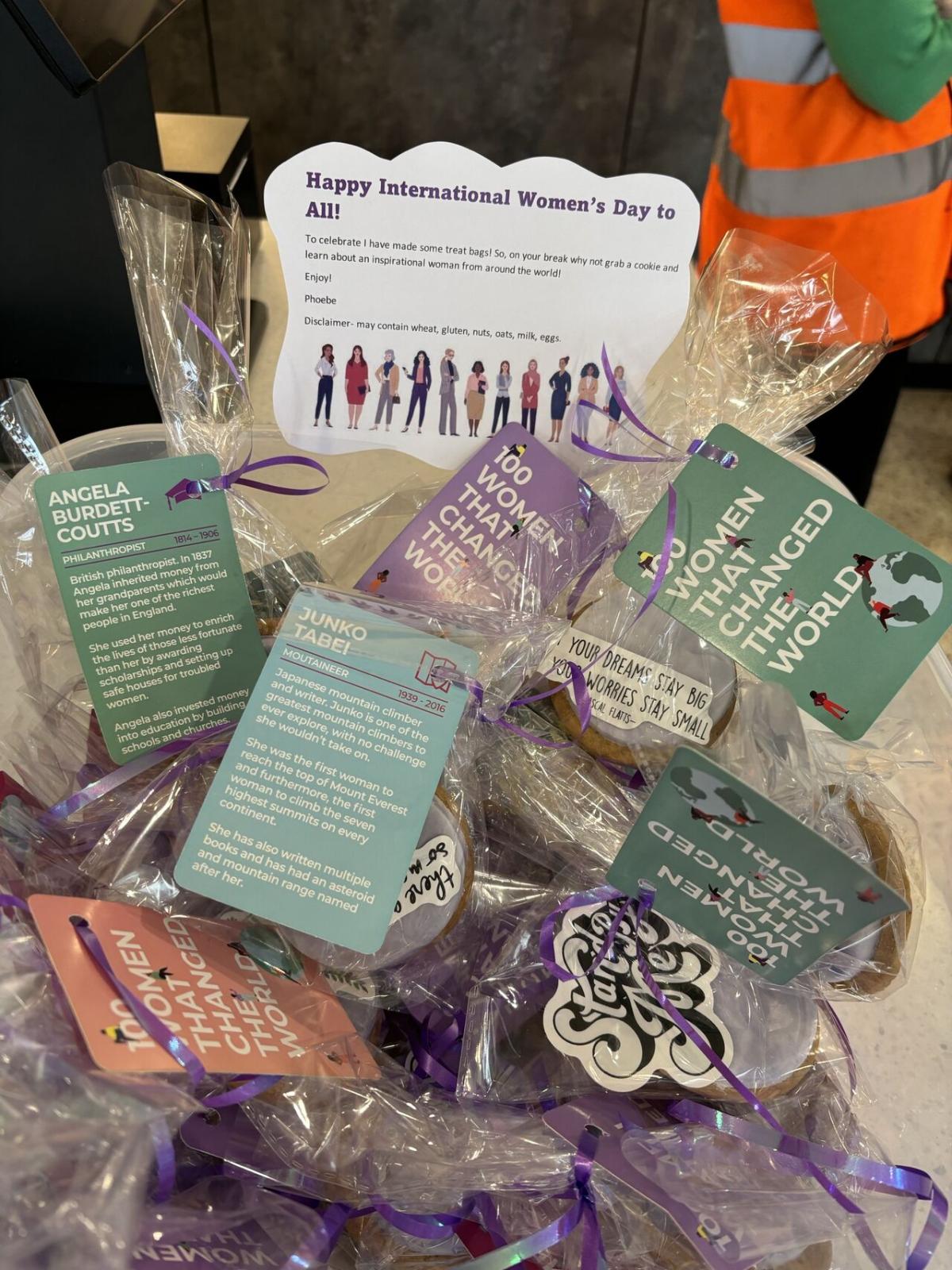 A box of individually wrapped cookies that have labels on providing information on inspirational women from around the world 