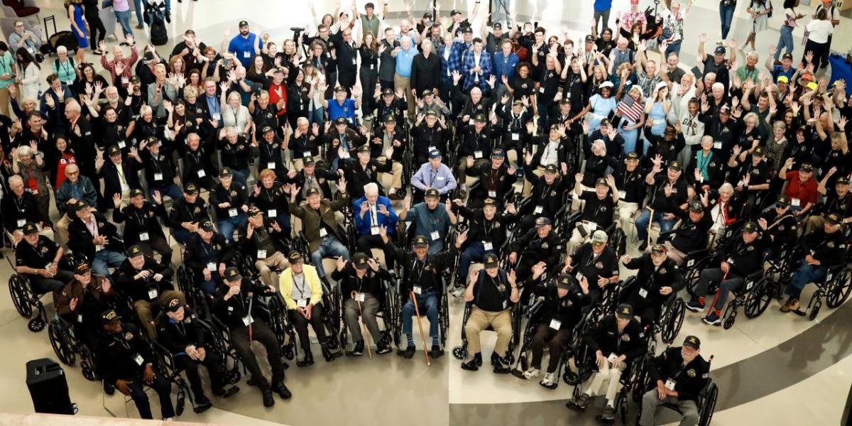 People waving for a large group photo