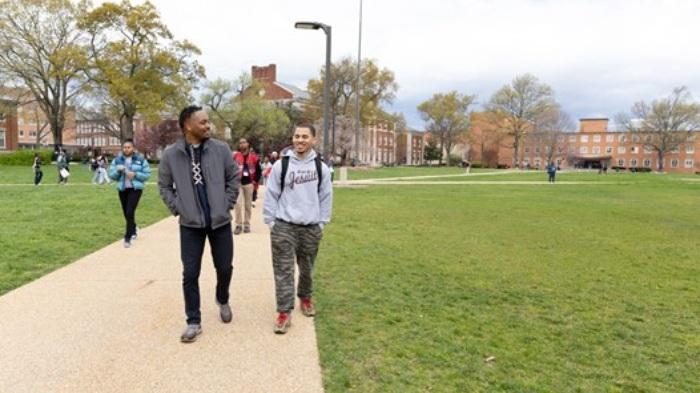 Two people walking on a campus