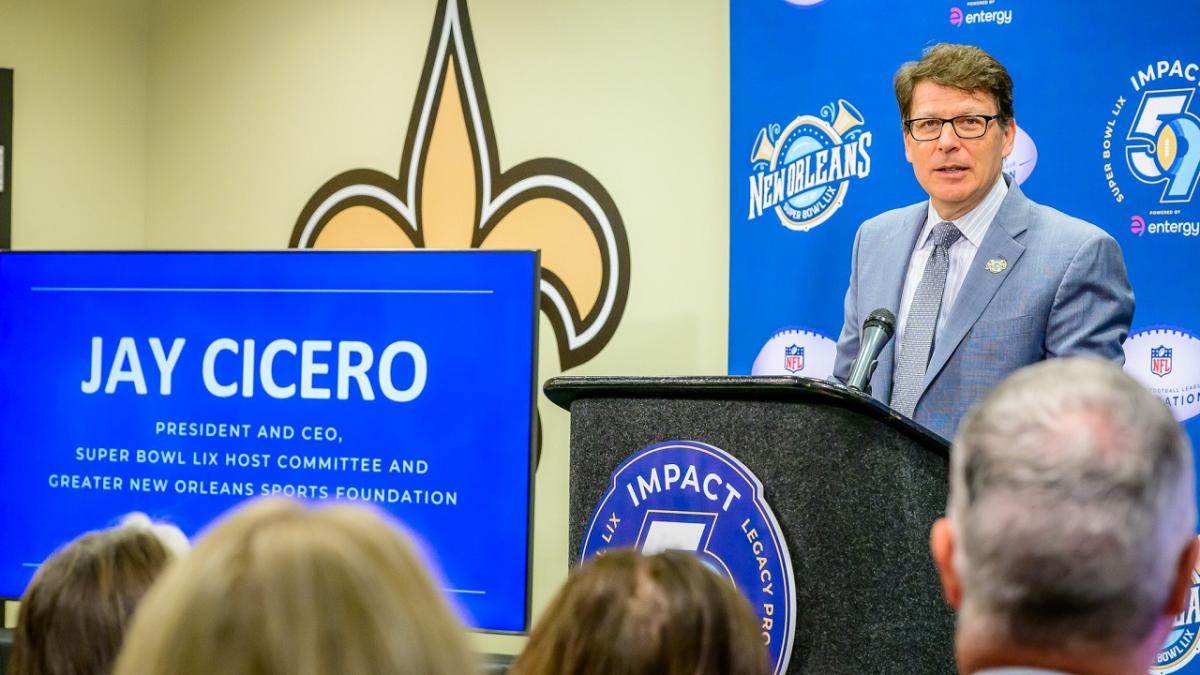 A person in a suit talking behind a podium