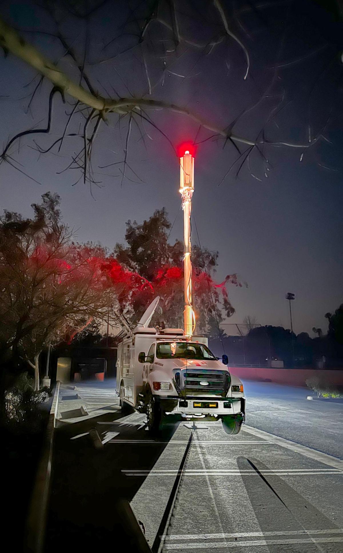 A T-Mobile vehicle in a parking lot at night