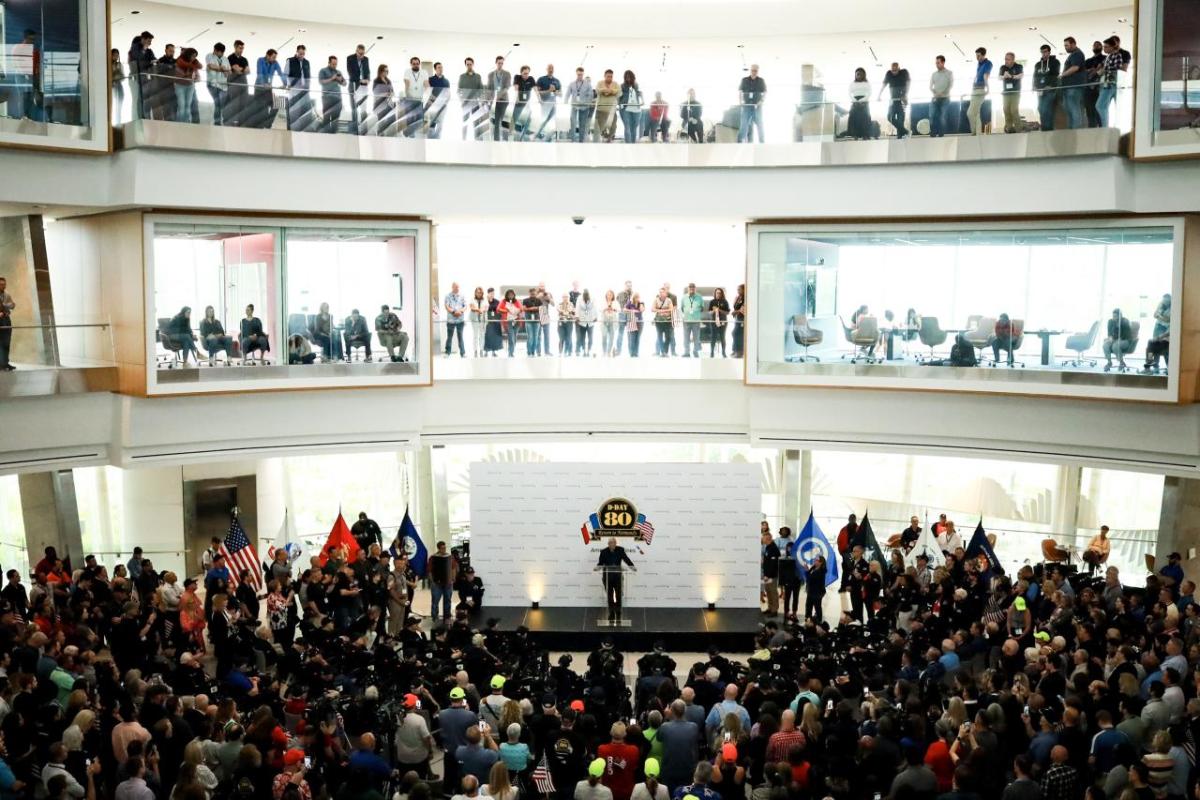 A large audience of people surrounding a stage 