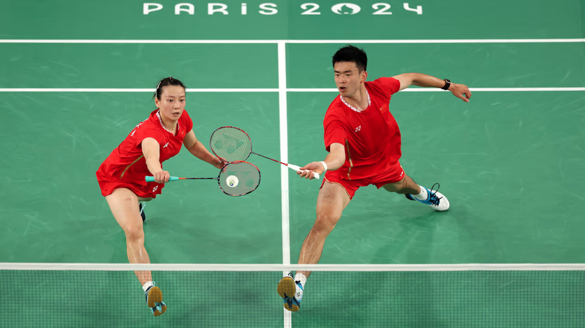 Two Olympians playing badminton