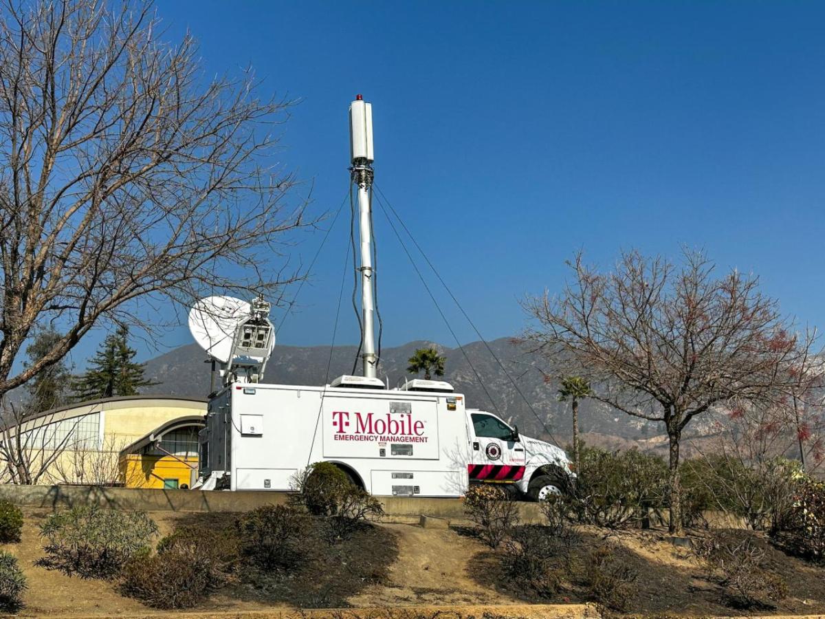 A T-Mobile vehicle with a satellite equipment near trees