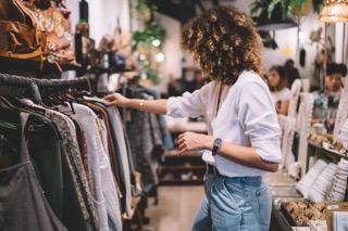 Woman looking at clothes on a rack in a shop