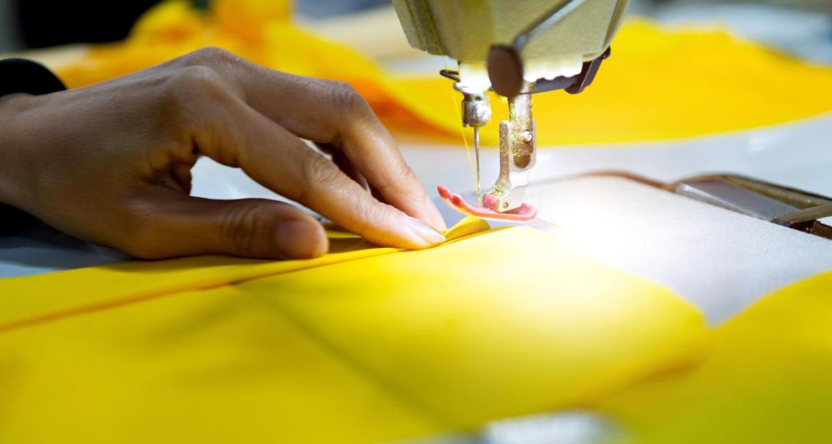 hands working on a sewing machine