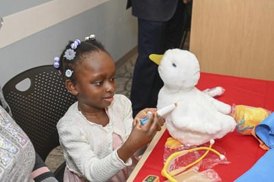 Child shown playing with her My Special Aflac Duck.