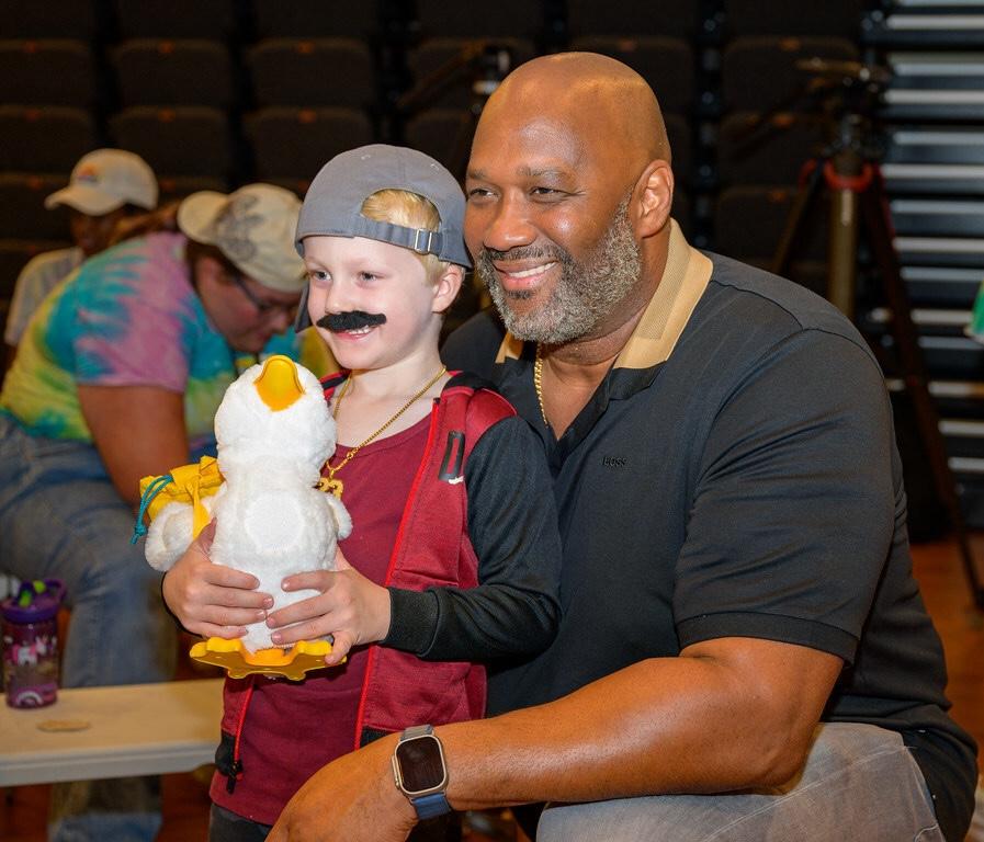 Aflac Duck Delivery. A young child is shown holding the Aflac Duck.