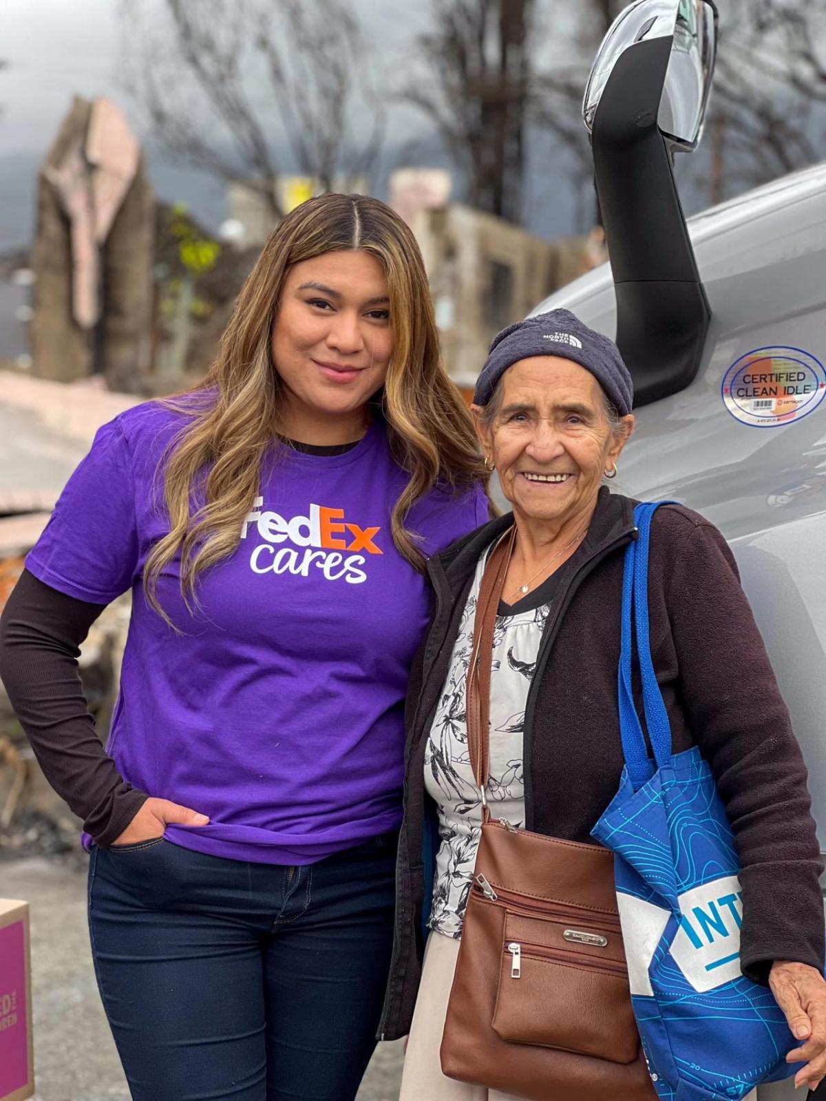 FedEx Cares volunteer with elderly woman