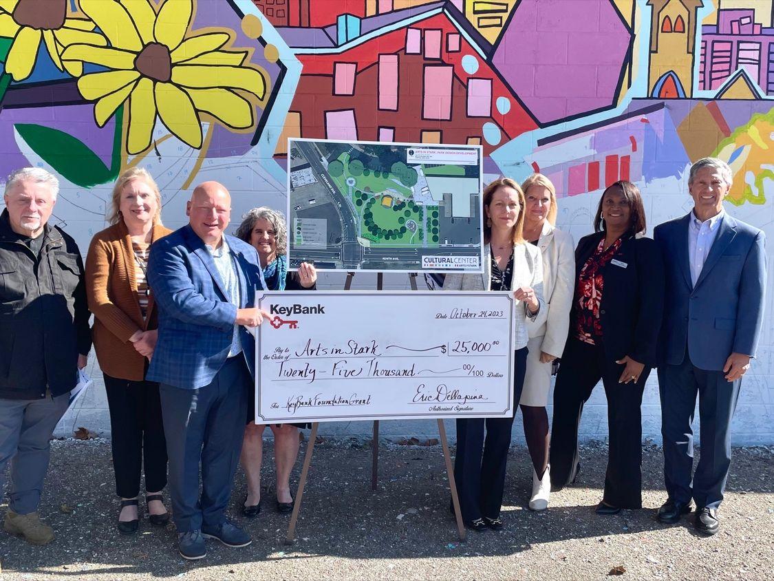 Representatives from ArtsInStark and KeyBank shown with a $25,000 grant check.