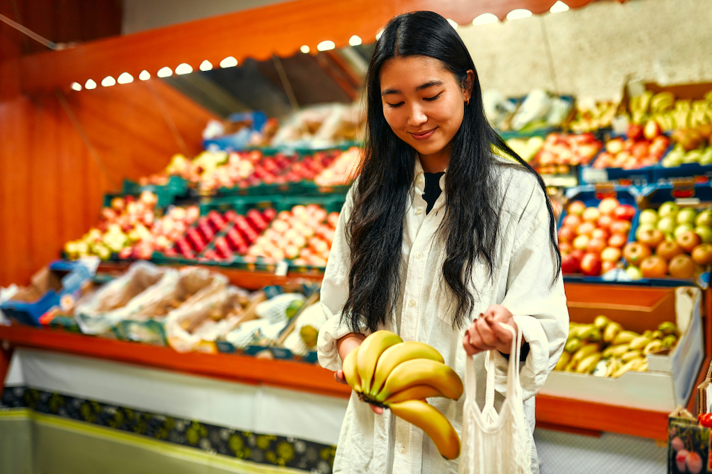 Asian woman shopping in the grocery store.
