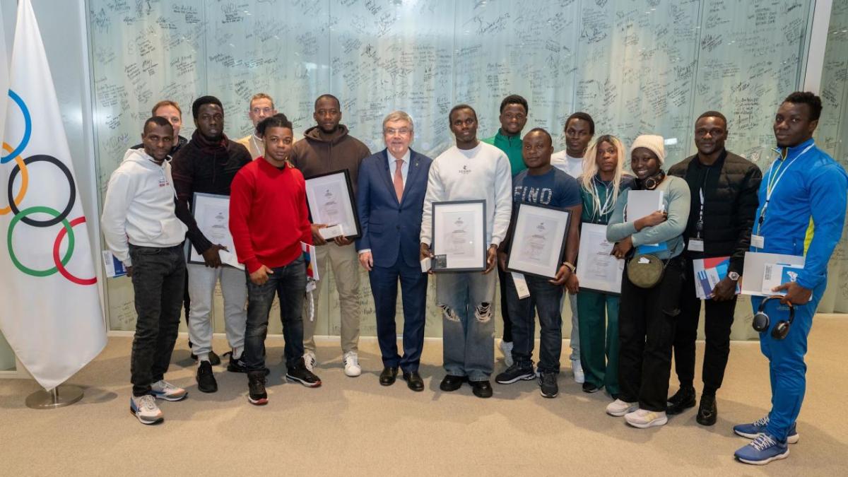 A group of people stood in a line holding awards