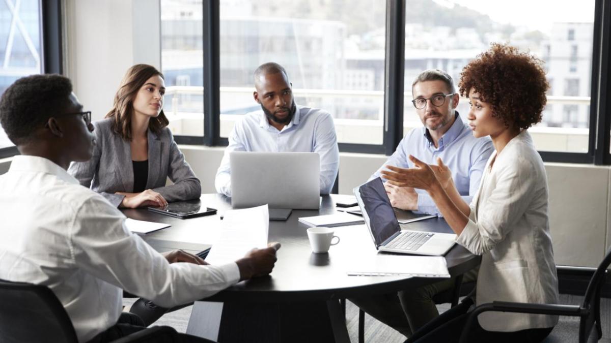 employees sitting around round table 