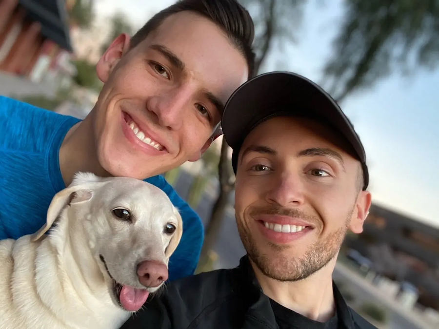 Ben and his husband holding his dog.