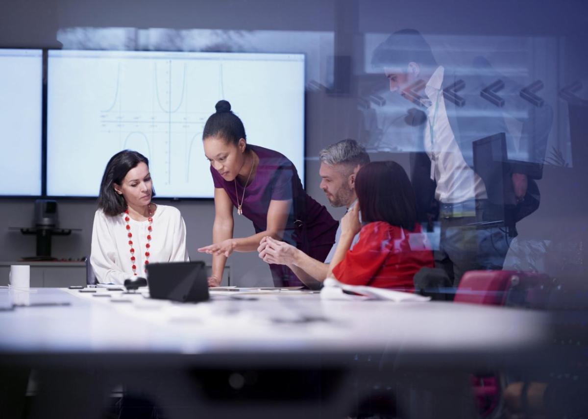 A team of people around an office table