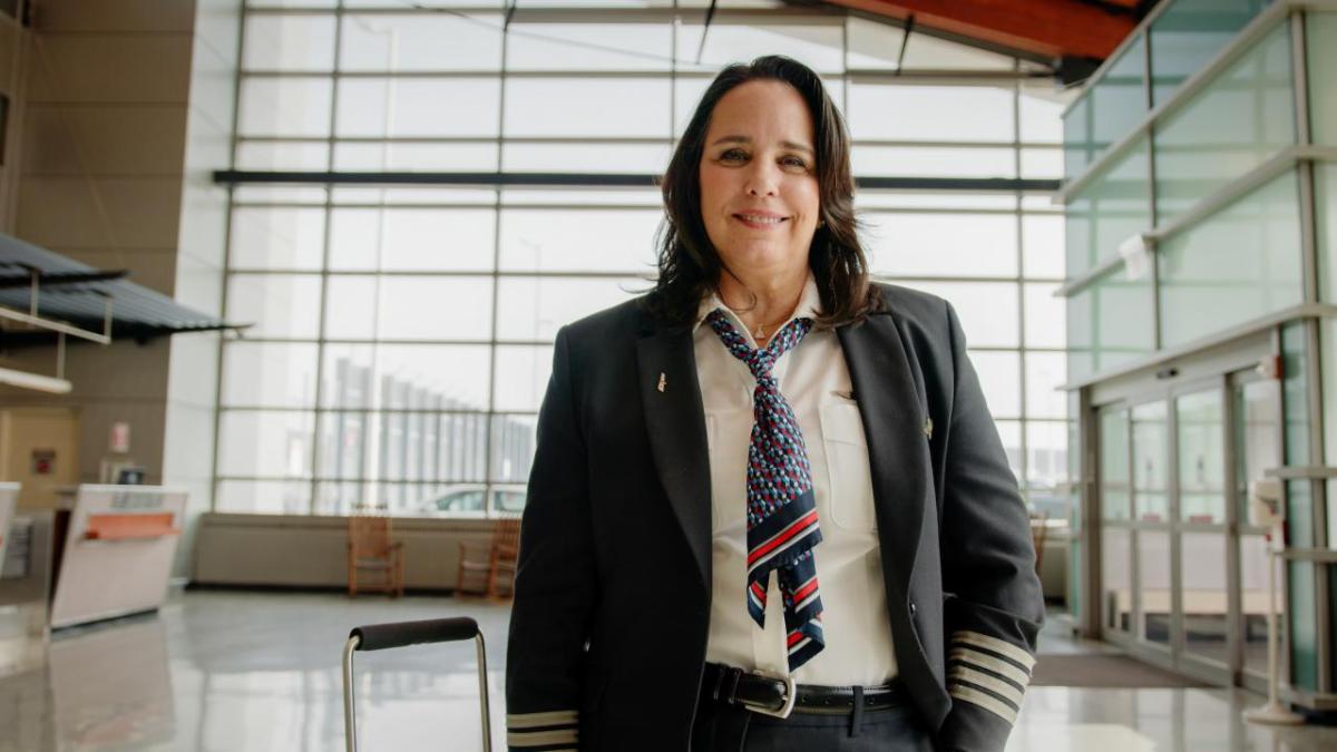 Captain Bridget Van Scoy wearing uniform inside an airport 