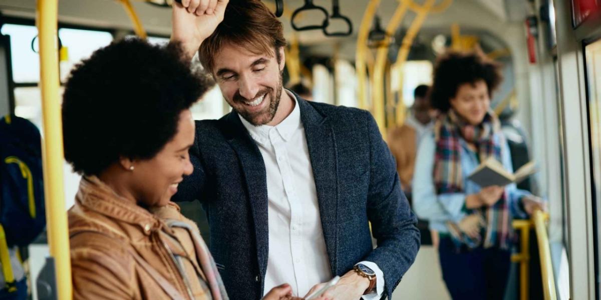 people stand while riding on a bus